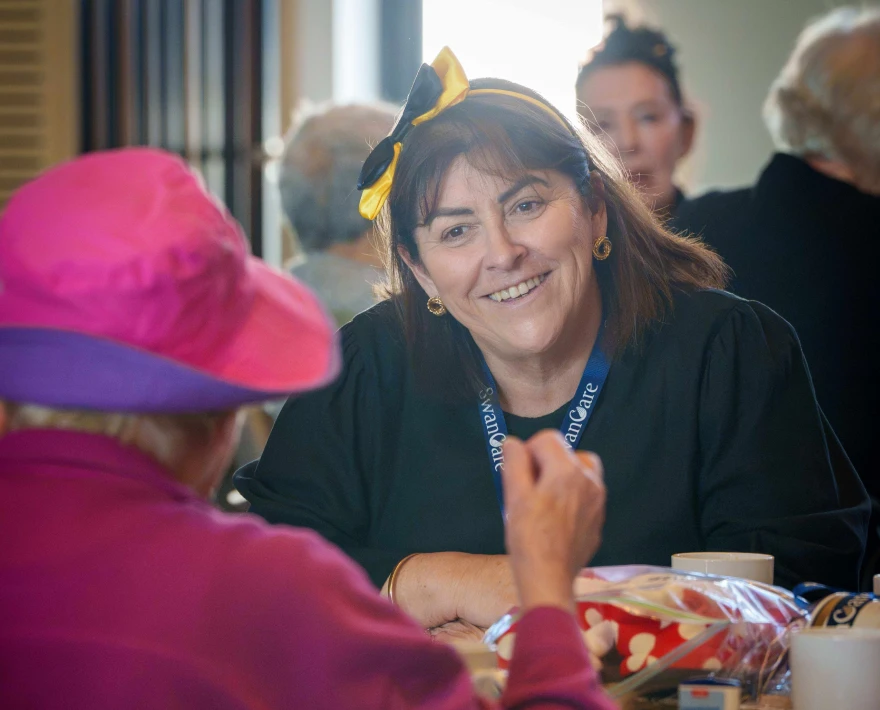 A SwanCare resident sharing a friendly handshake at the Bentley Park campus