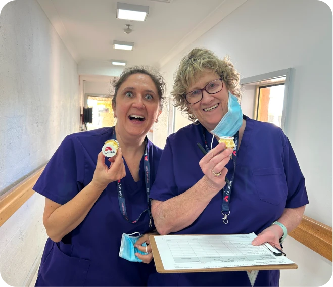 Photo of a team with sticky notes in the background