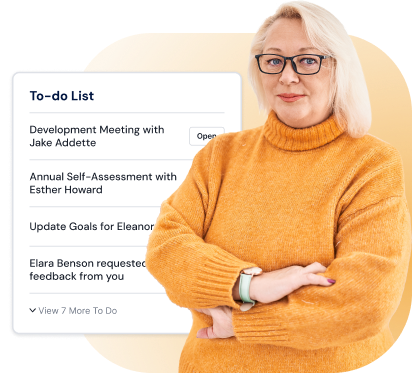 Woman smiling in front of a to-do list that shows things like development meetings, annual self-assessment meetings, etc